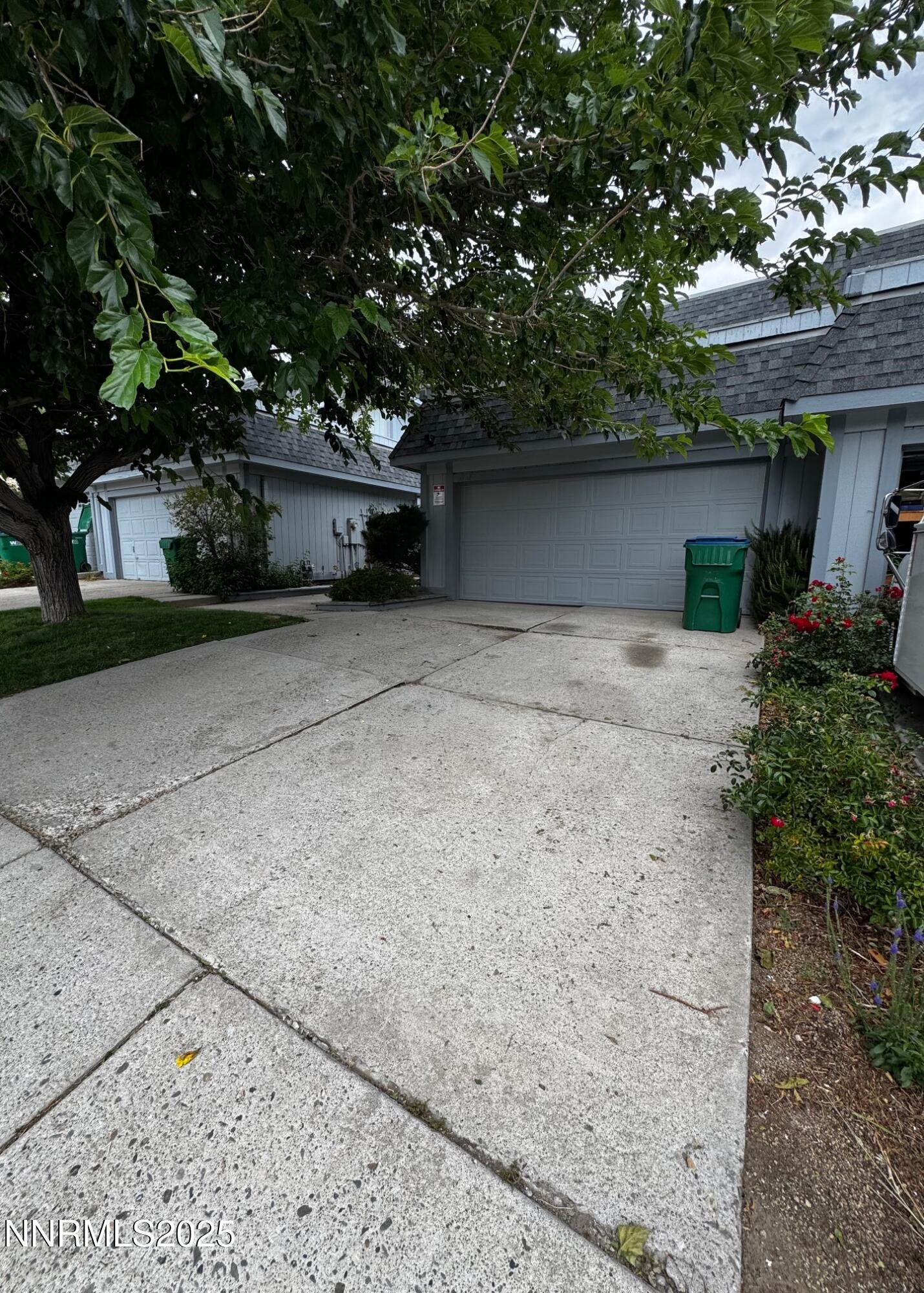 a front view of a house with a yard and a garage