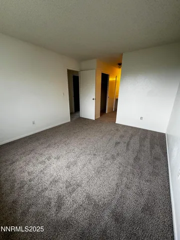 a view of an empty room with a closet