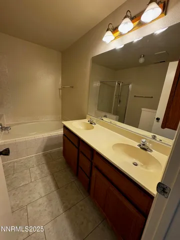 a bathroom with a tub a sink and a shower