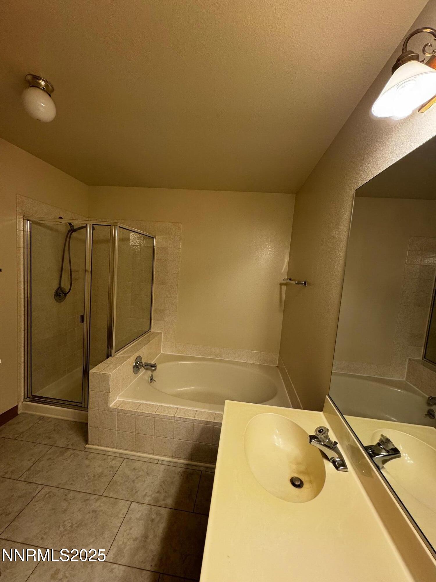 3967 Kings Row Reno, NV 89503 - Photo 19 of 21 a bathroom with a tub a sink and a shower