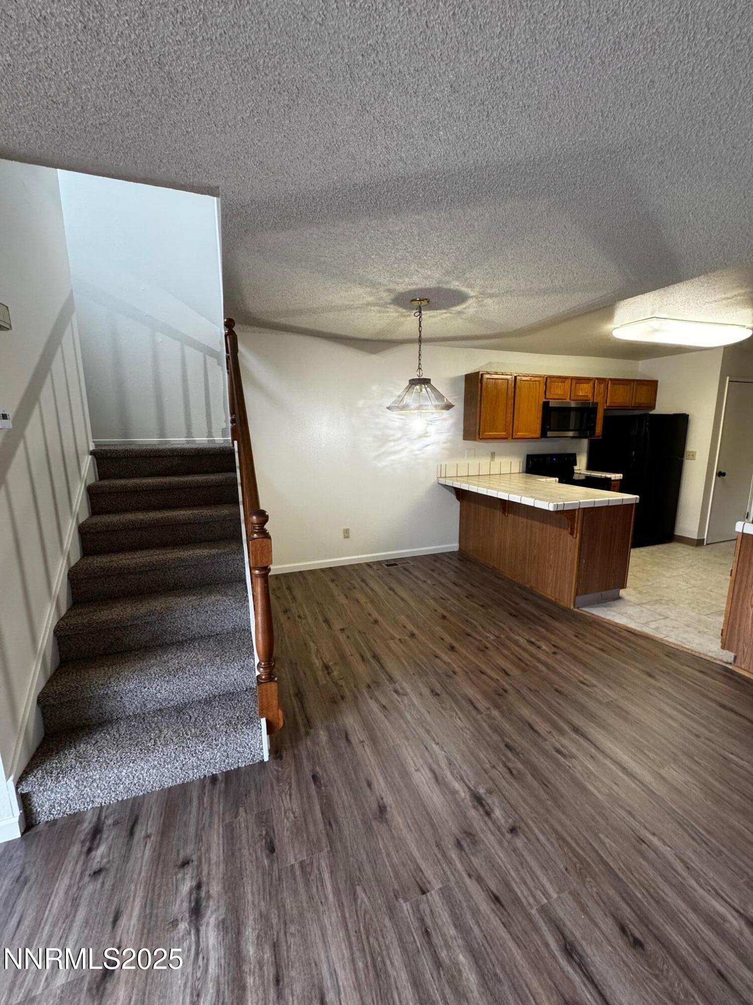 3967 Kings Row Reno, NV 89503 - Photo 5 of 21 a view of entryway and kitchen with wooden floor