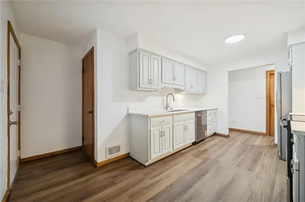 a kitchen with stainless steel appliances granite countertop a stove a sink and a refrigerator