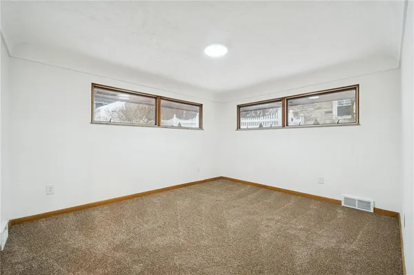 a view of an empty room with painting on the wall