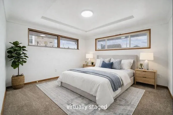 a bedroom with a bed and a potted plant