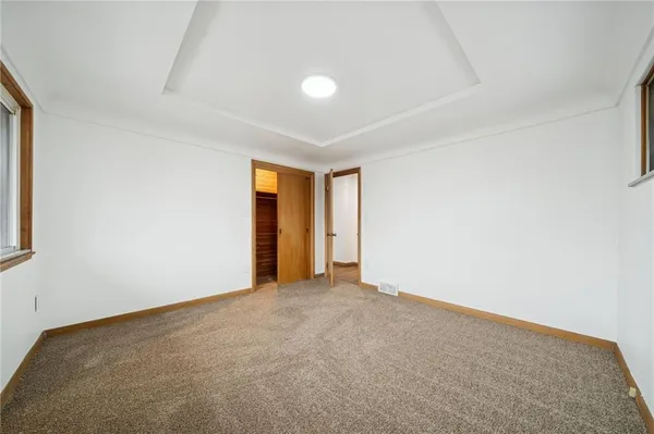 an empty room with an entryway and window