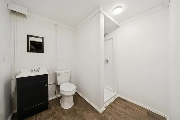 a bathroom with a toilet a sink and mirror