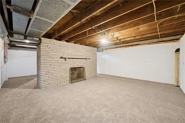 a view of an empty room with a fireplace
