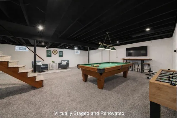 a bedroom with furniture and a flat screen tv