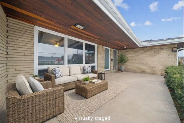 a balcony with furniture and a potted plant