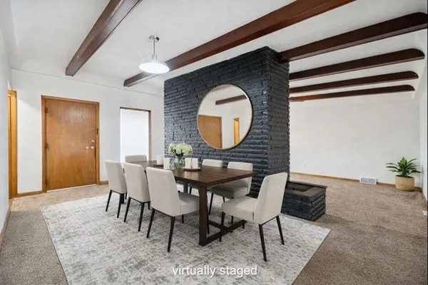 a dining room with furniture and a mirror