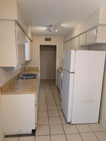 a kitchen with a refrigerator and a stove