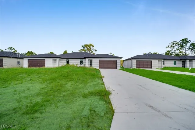 a view of a house with a yard and a porch