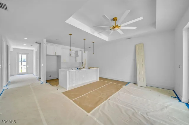 a view of a livingroom with a ceiling fan and window