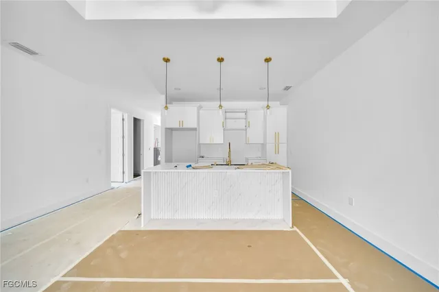 a view of kitchen with refrigerator stove and wooden floor