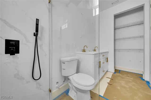 a bathroom with a toilet sink and shower