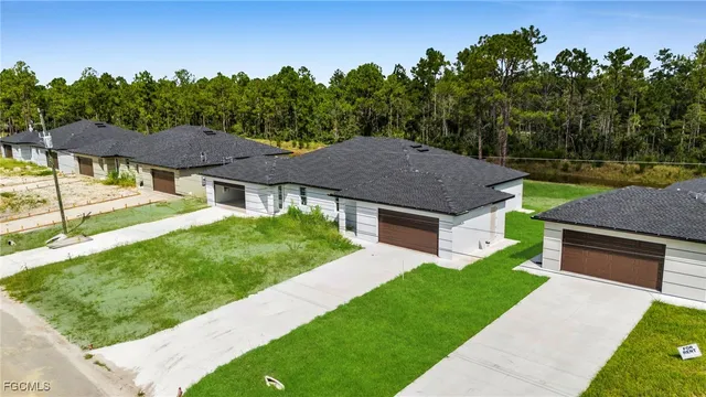 a aerial view of a house with a yard table and chairs