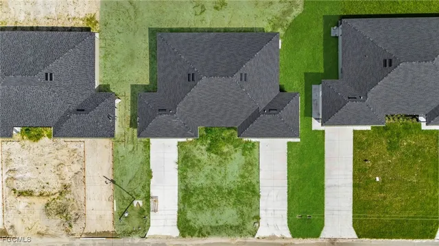 an aerial view of a house with a yard