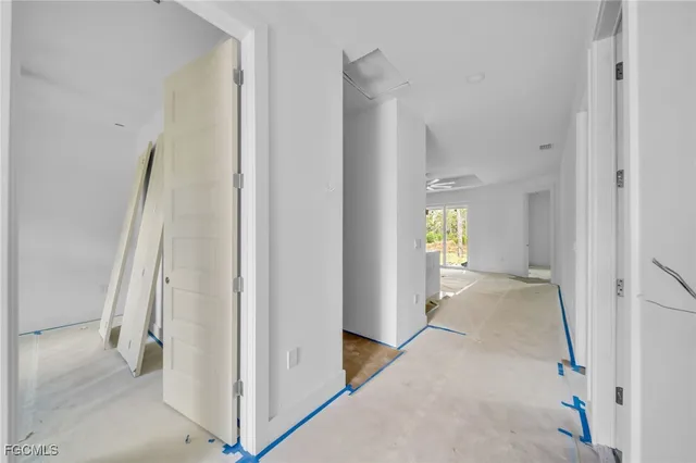 a view of a hallway with wooden floor and entryway