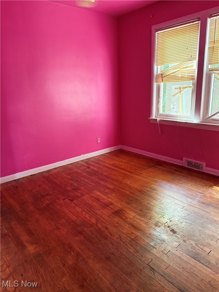 20682 Centuryway Road Maple Heights, OH 44137 - Photo 9 of 16 Empty room with baseboards and hardwood / wood-style floors