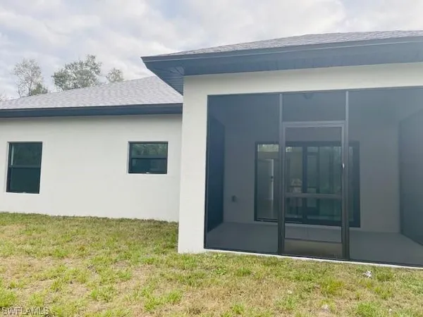 a kitchen with stainless steel appliances granite countertop a stove a sink dishwasher a dining table and chairs with wooden floor