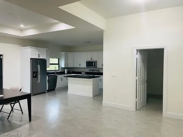 a view of a room with wooden floor and white walls