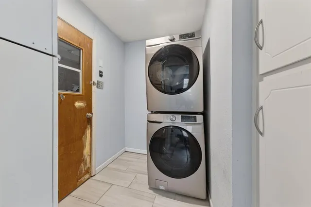 a view of a hallway with washer and dryer