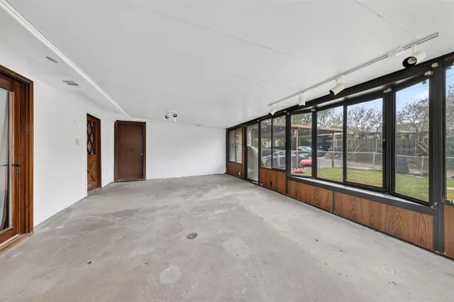 a view of an empty room with large windows