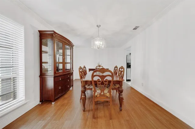 a dining room with furniture and wooden floor