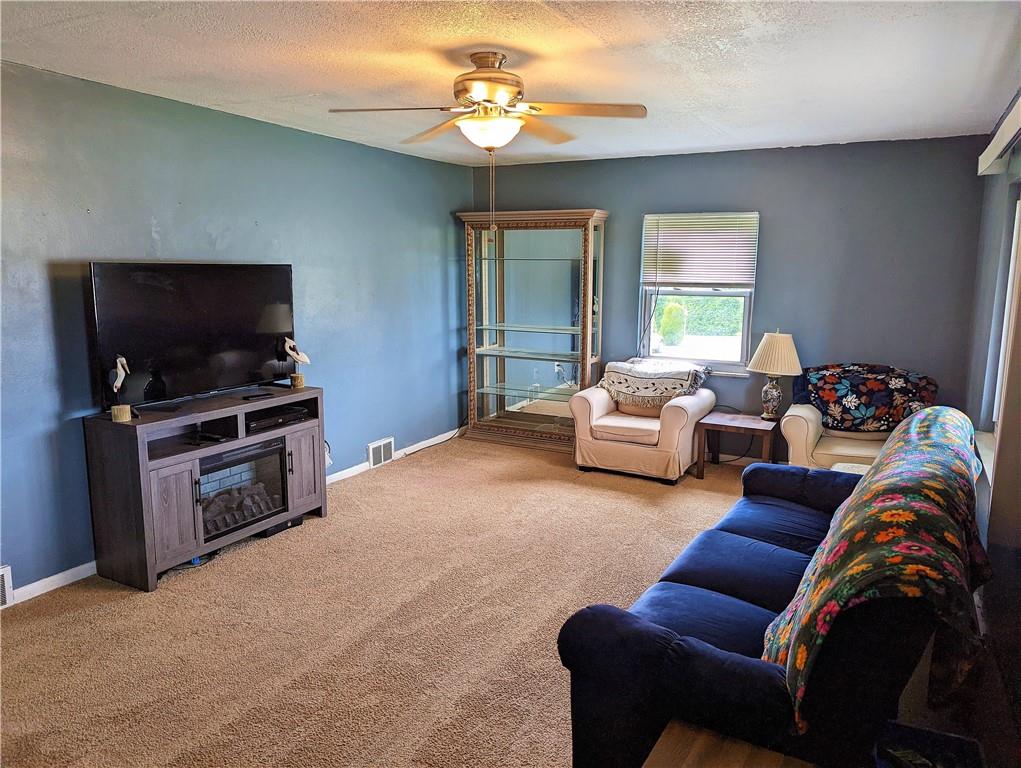1112 New Castle Road Prospect, PA 16052 - Photo 2 of 25 a living room with furniture a flat screen tv and a window