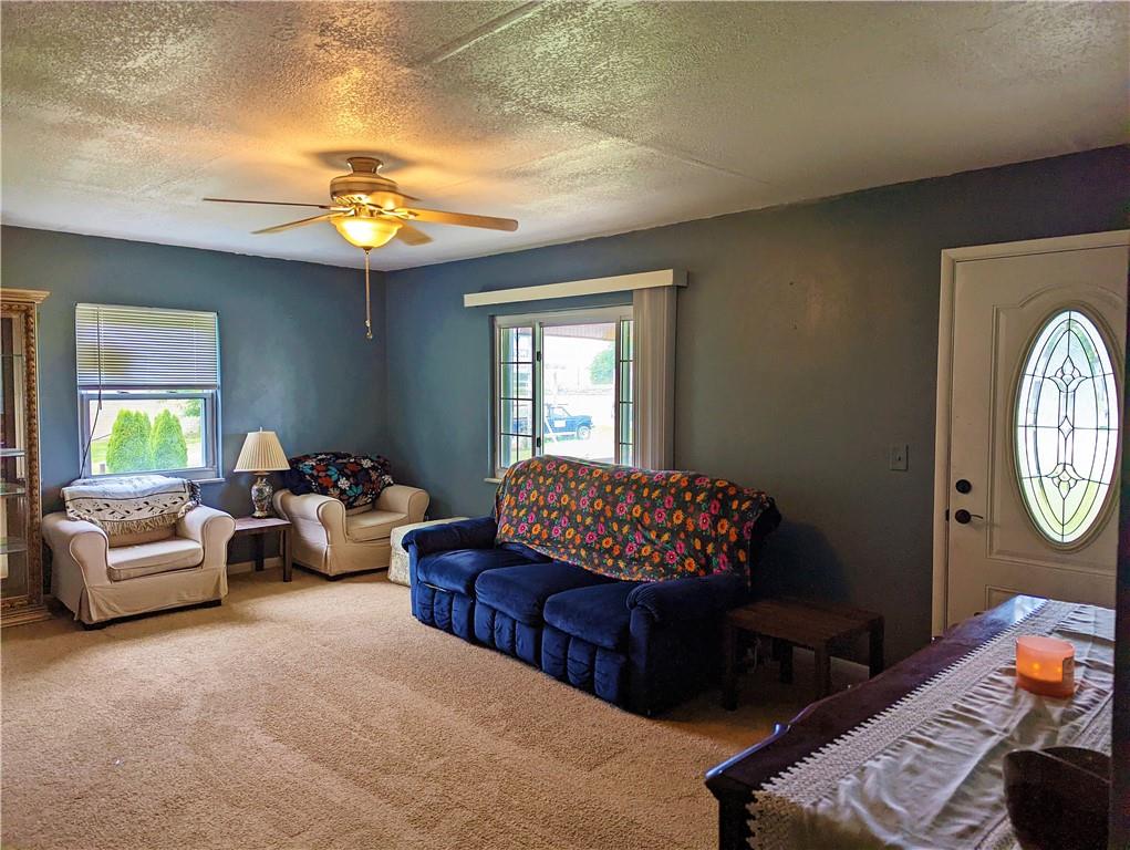 1112 New Castle Road Prospect, PA 16052 - Photo 3 of 25 a living room with furniture a chandelier and a window