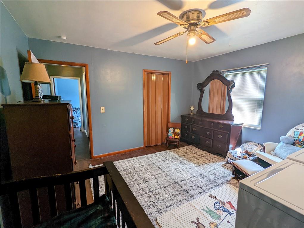 1112 New Castle Road Prospect, PA 16052 - Photo 8 of 25 a bedroom with a bed and a chandelier