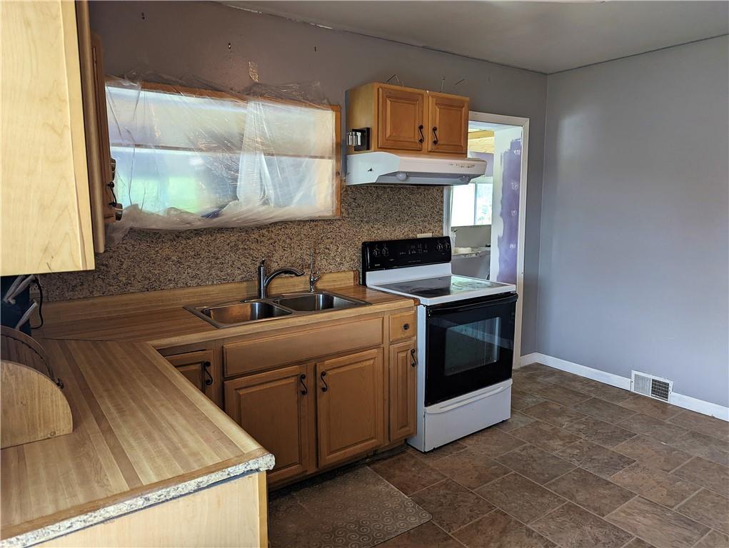 1112 New Castle Road Prospect, PA 16052 - Photo 9 of 25 a kitchen with a sink stove and microwave
