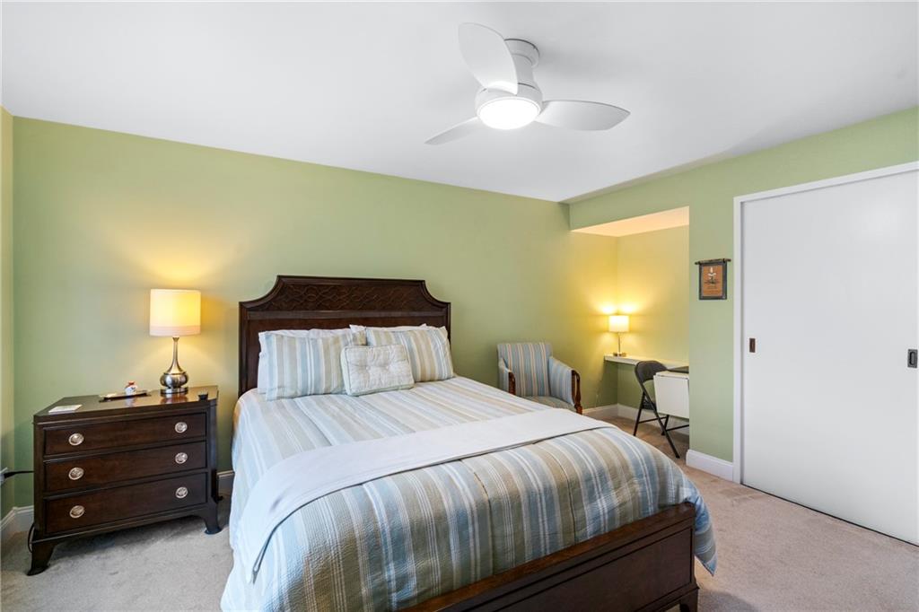 415 Bigham Street, Unit 23 Pittsburgh, PA 15211 - Photo 16 of 24 a bedroom with a bed and a chandelier