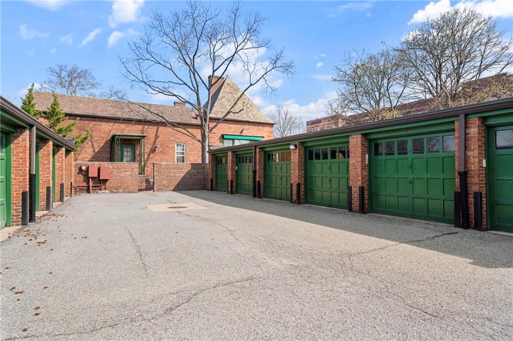 415 Bigham Street, Unit 23 Pittsburgh, PA 15211 - Photo 22 of 24 a view of a house with a yard and garage