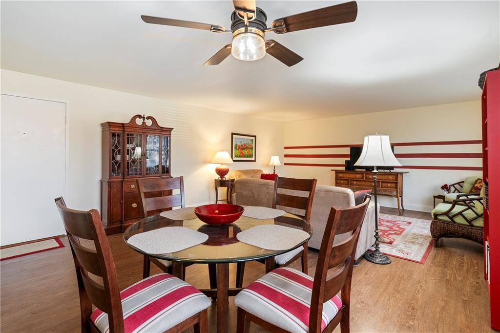 415 Bigham Street, Unit 23 Pittsburgh, PA 15211 - Photo 6 of 24 a view of a dining room with furniture and wooden floor