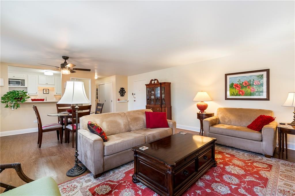 415 Bigham Street, Unit 23 Pittsburgh, PA 15211 - Photo 9 of 24 a living room with furniture a rug and a chandelier