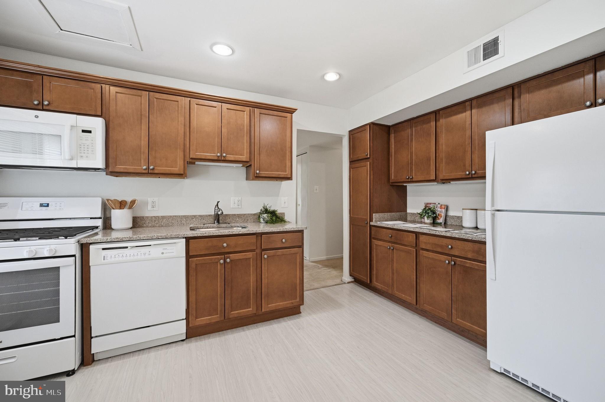 1659 Parkcrest Circle, Unit C Reston, VA 20190 - Photo 19 of 31 a kitchen with stainless steel appliances granite countertop a refrigerator sink stove and microwave