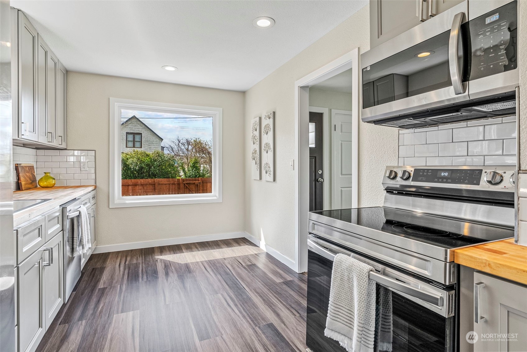 1312 Summit Street Aberdeen, WA 98520 - Photo 14 of 37 a kitchen with a wooden floor and stainless steel appliances