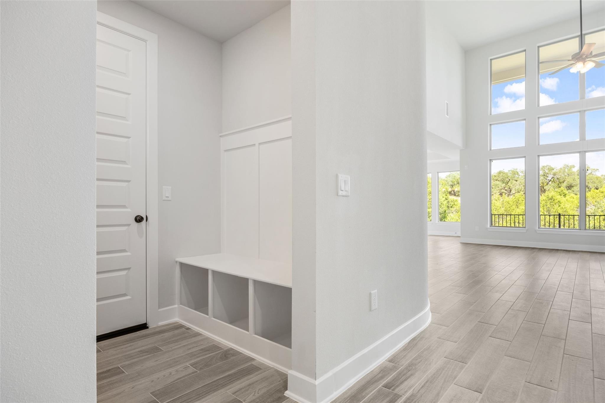 1417 Rodeo Ridge Drive Georgetown, TX 78628 - Photo 18 of 37 Mudroom featuring wood tiled floors, ceiling fan, and a high ceiling