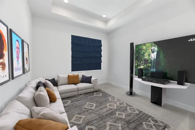 a living room with furniture ceiling fan and a rug