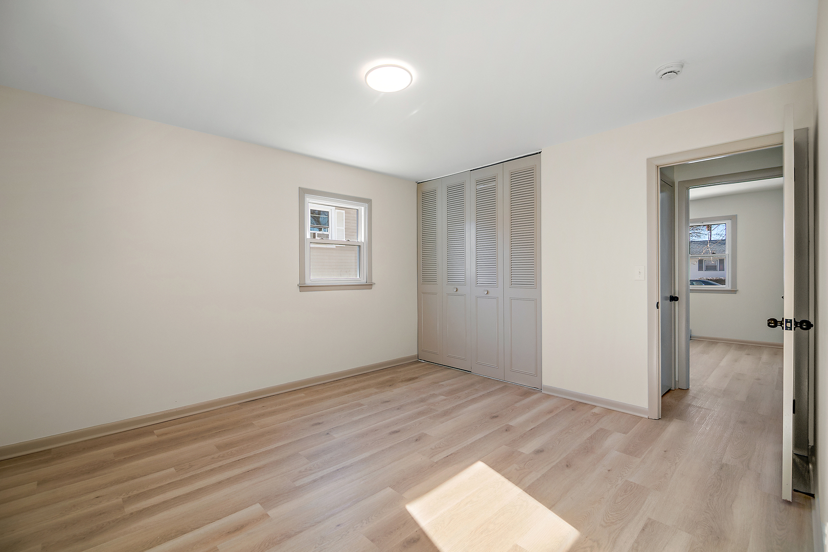 208 Sycamore Lane Momence, IL 60954 - Photo 13 of 19 an empty room with wooden floor and windows