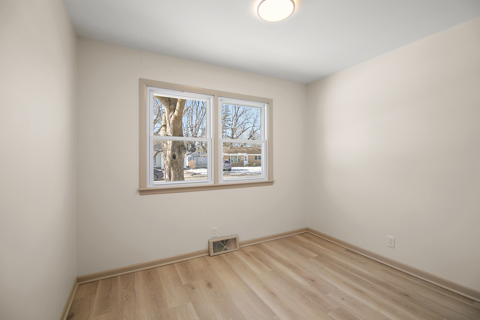 208 Sycamore Lane Momence, IL 60954 - Photo 15 of 19 a view of an empty room with wooden floor and a window