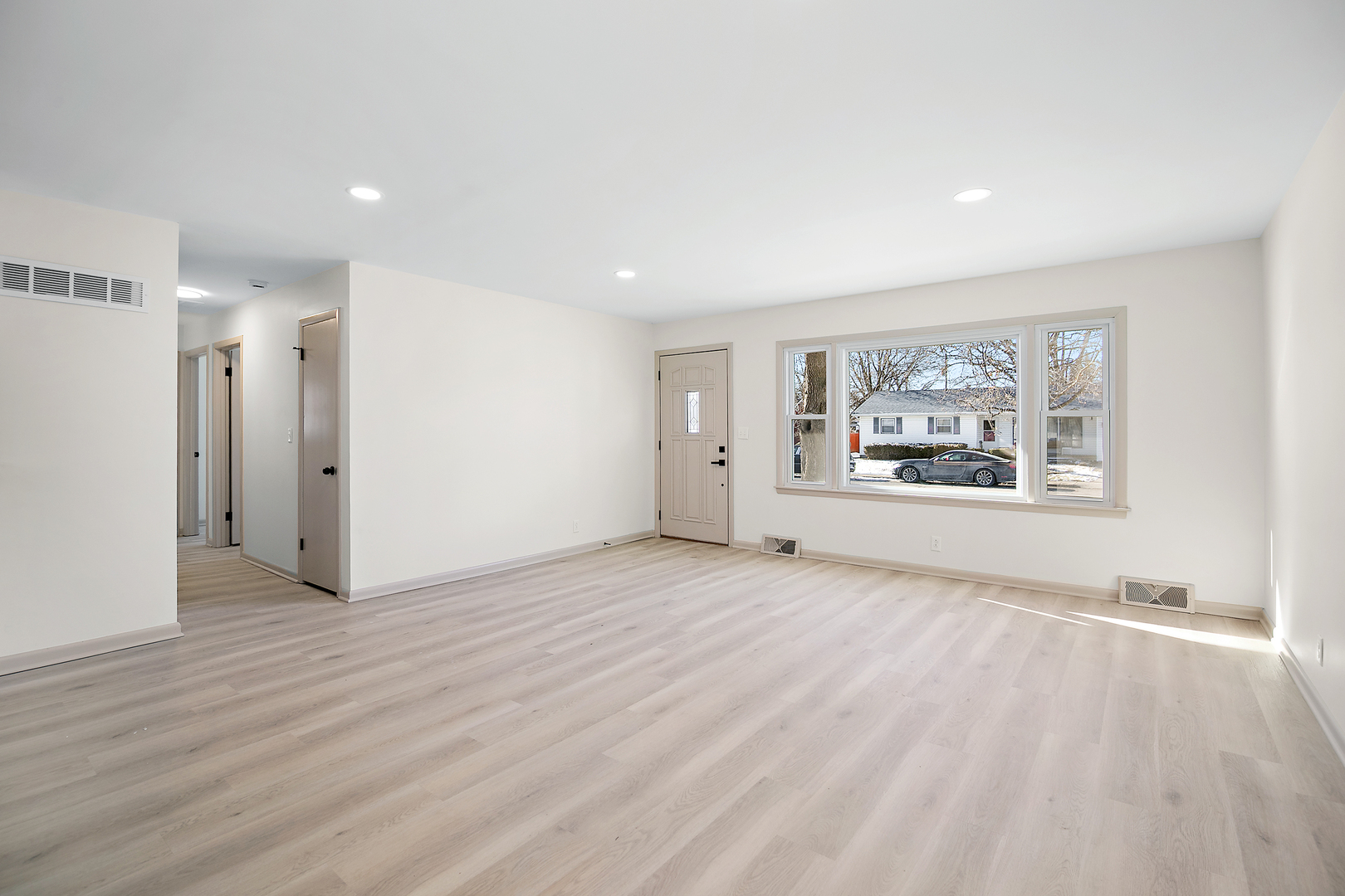 208 Sycamore Lane Momence, IL 60954 - Photo 16 of 19 a view of an empty room with a window and a kitchen
