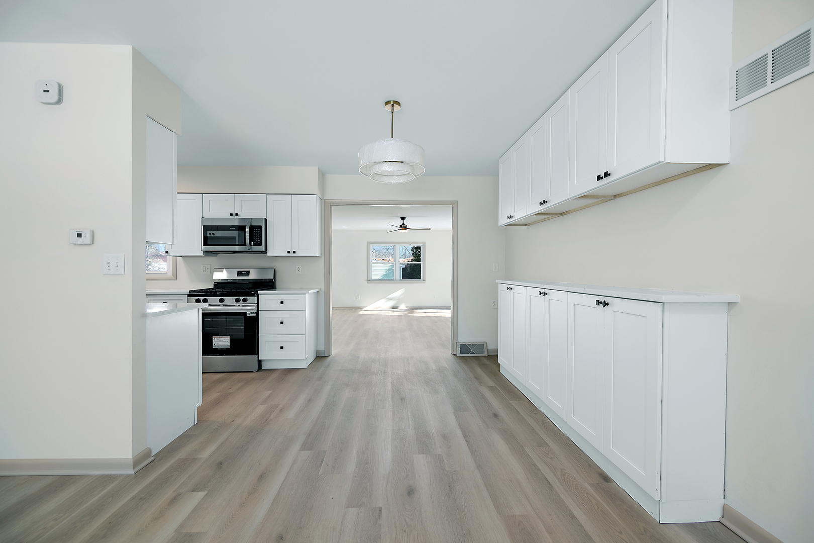 208 Sycamore Lane Momence, IL 60954 - Photo 4 of 19 a large kitchen with cabinets wooden floor and stainless steel appliances