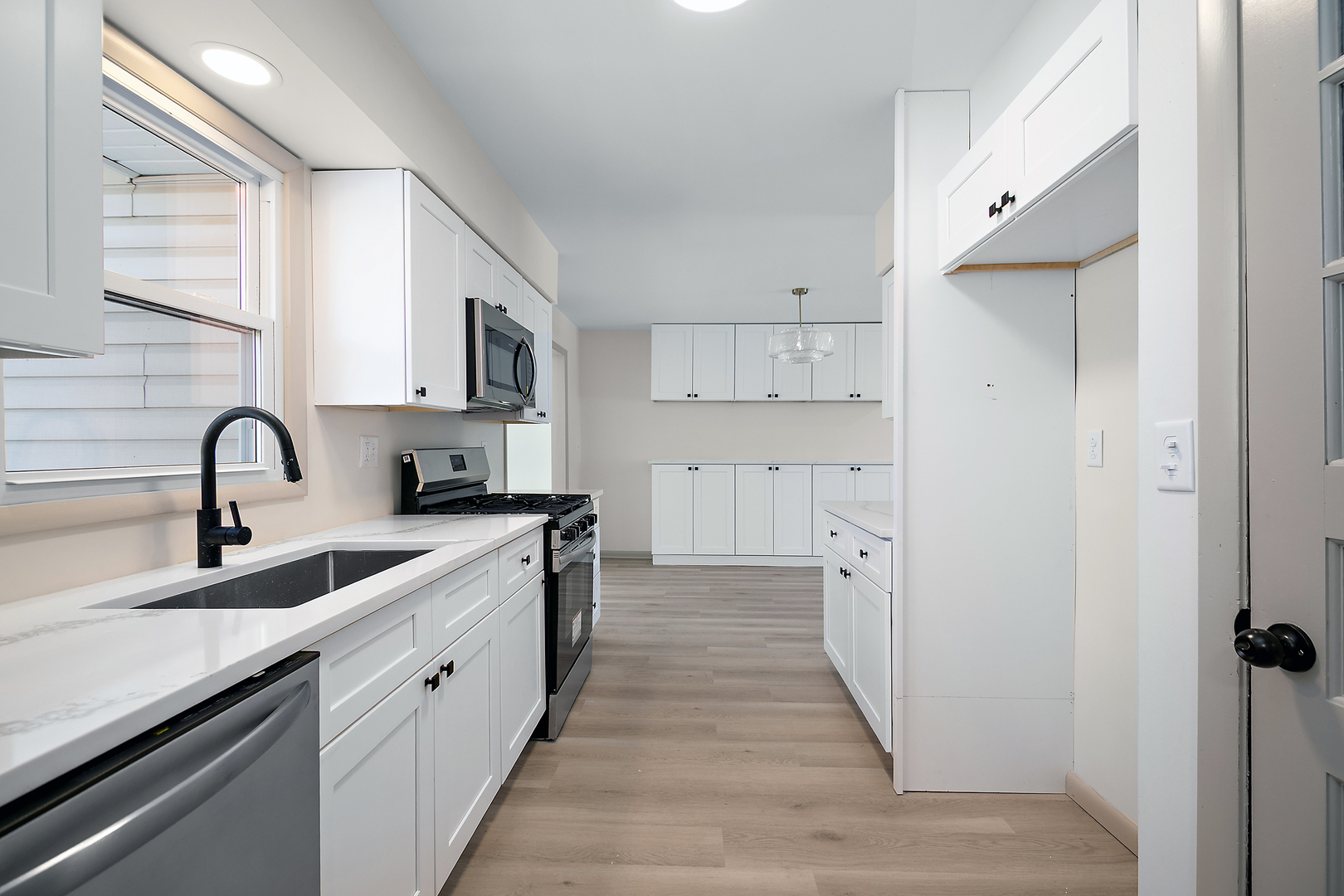 208 Sycamore Lane Momence, IL 60954 - Photo 7 of 19 a kitchen with white cabinets and a sink