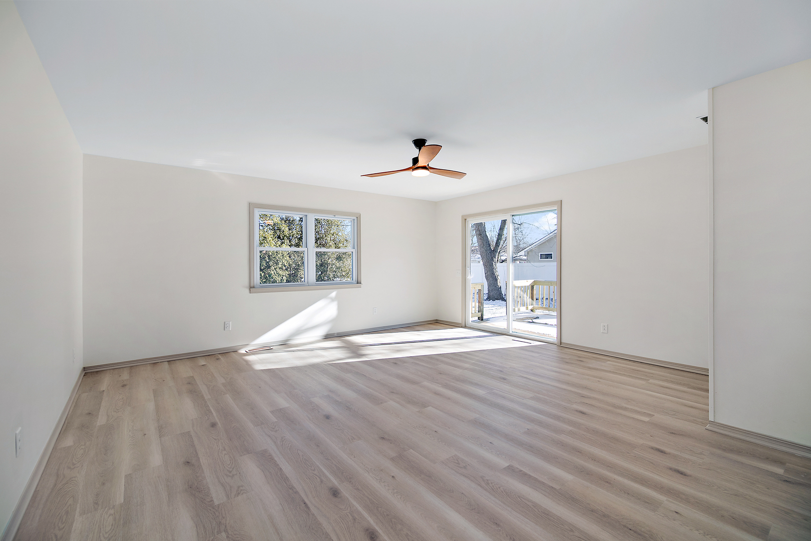 208 Sycamore Lane Momence, IL 60954 - Photo 8 of 19 a view of empty room with wooden floor and fan
