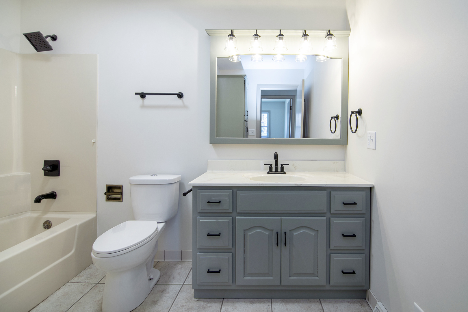 208 Sycamore Lane Momence, IL 60954 - Photo 10 of 19 a bathroom with a sink vanity mirror bathtub and toilet