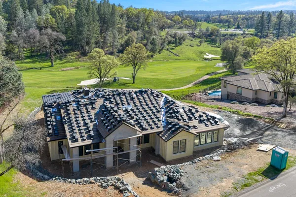 an aerial view of a house with a yard