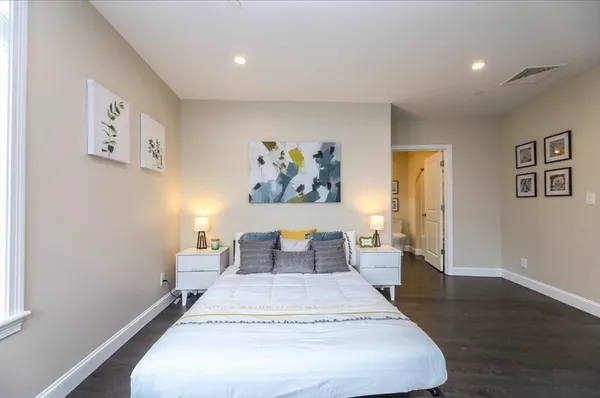 a bedroom with a bed and a large window