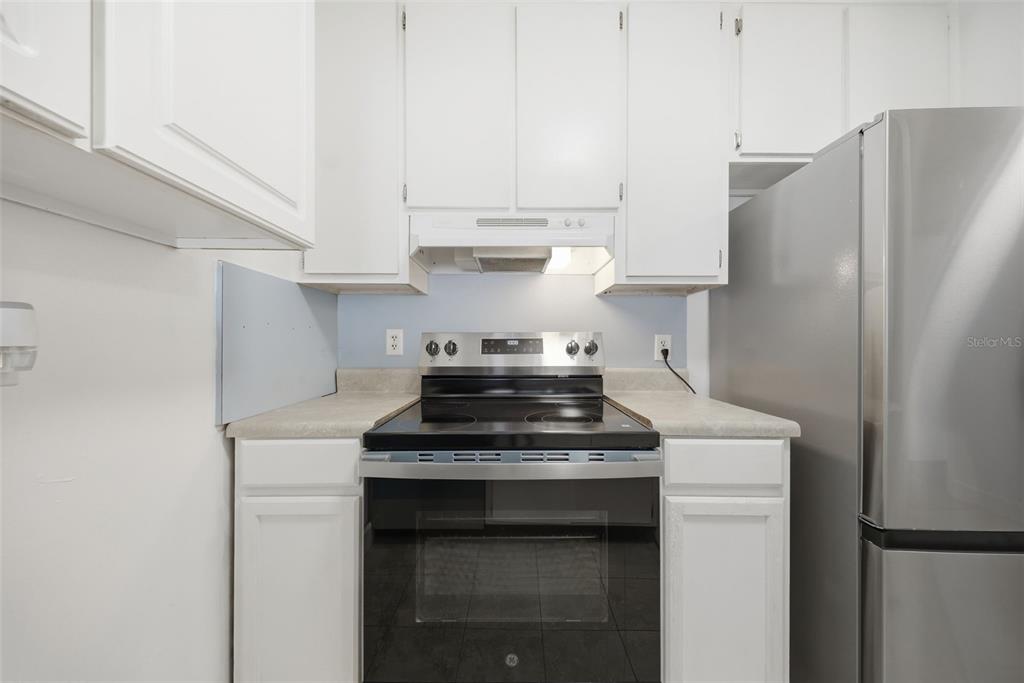 141 Fernery Road, Unit A3 Lakeland, FL 33809 - Photo 7 of 40 a kitchen with stainless steel appliances a stove and a refrigerator